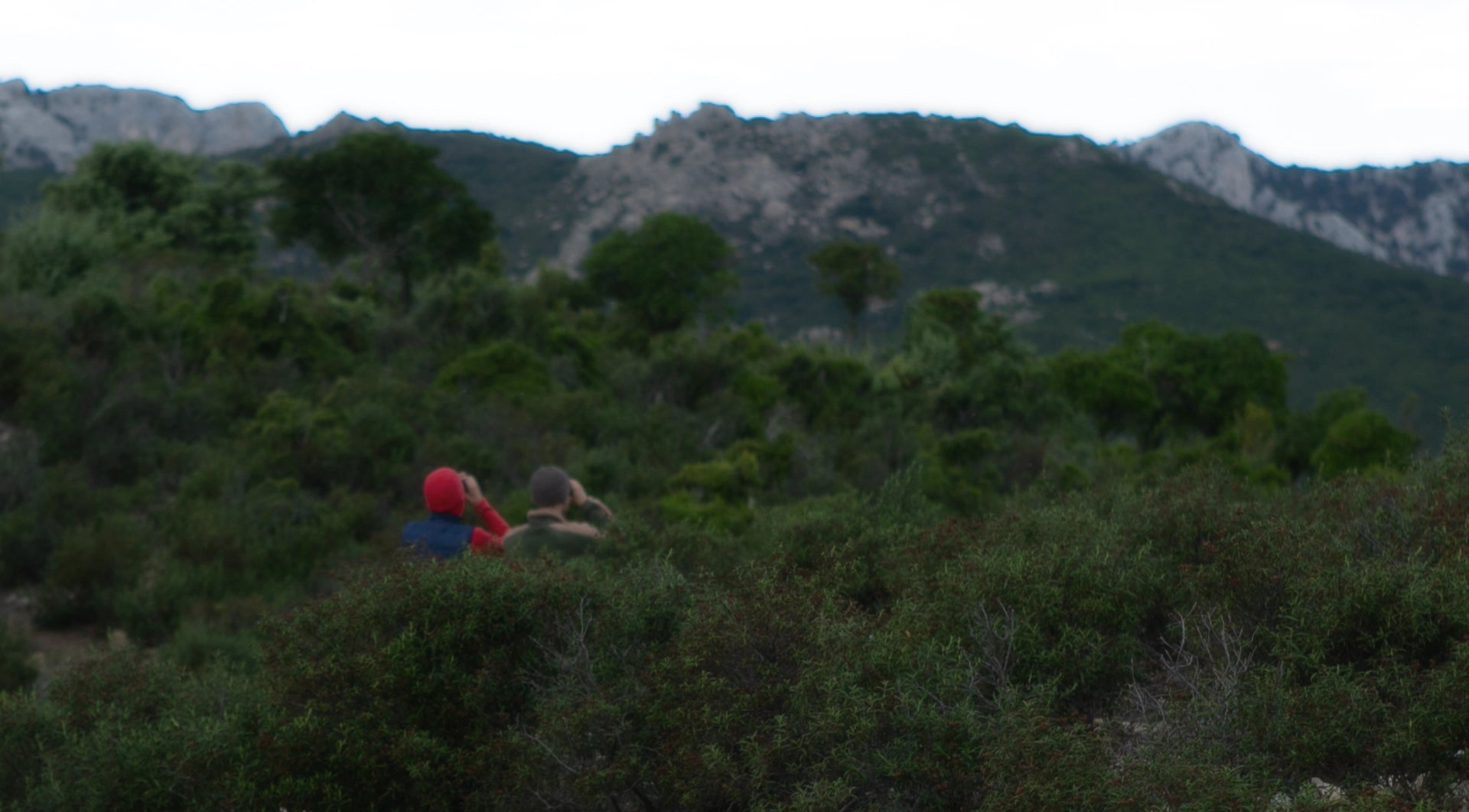 Climbers looking for rock faces in Sardinia Italy.