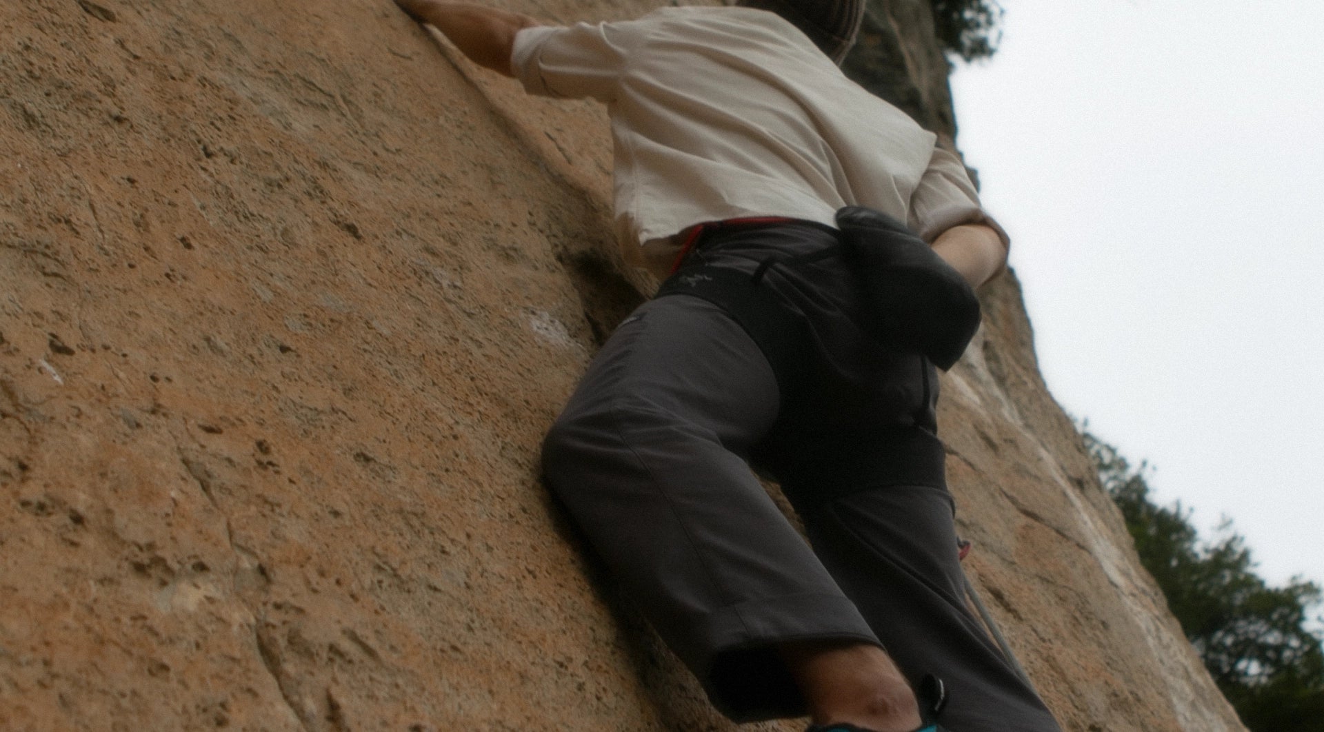 Rock climber scaling on limestone in the climbing crag Ulassai Sardegna Italy.