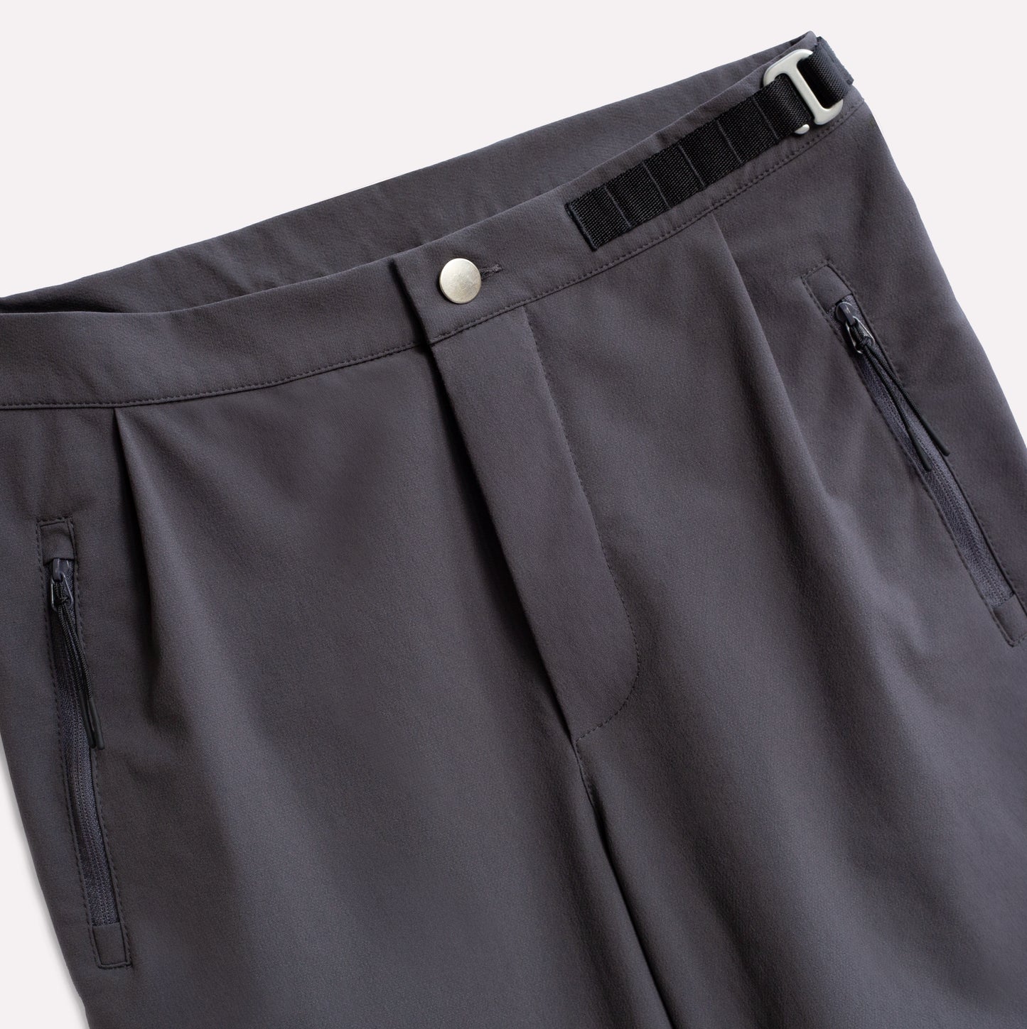 Grey pants for climbing with zip pockets.
