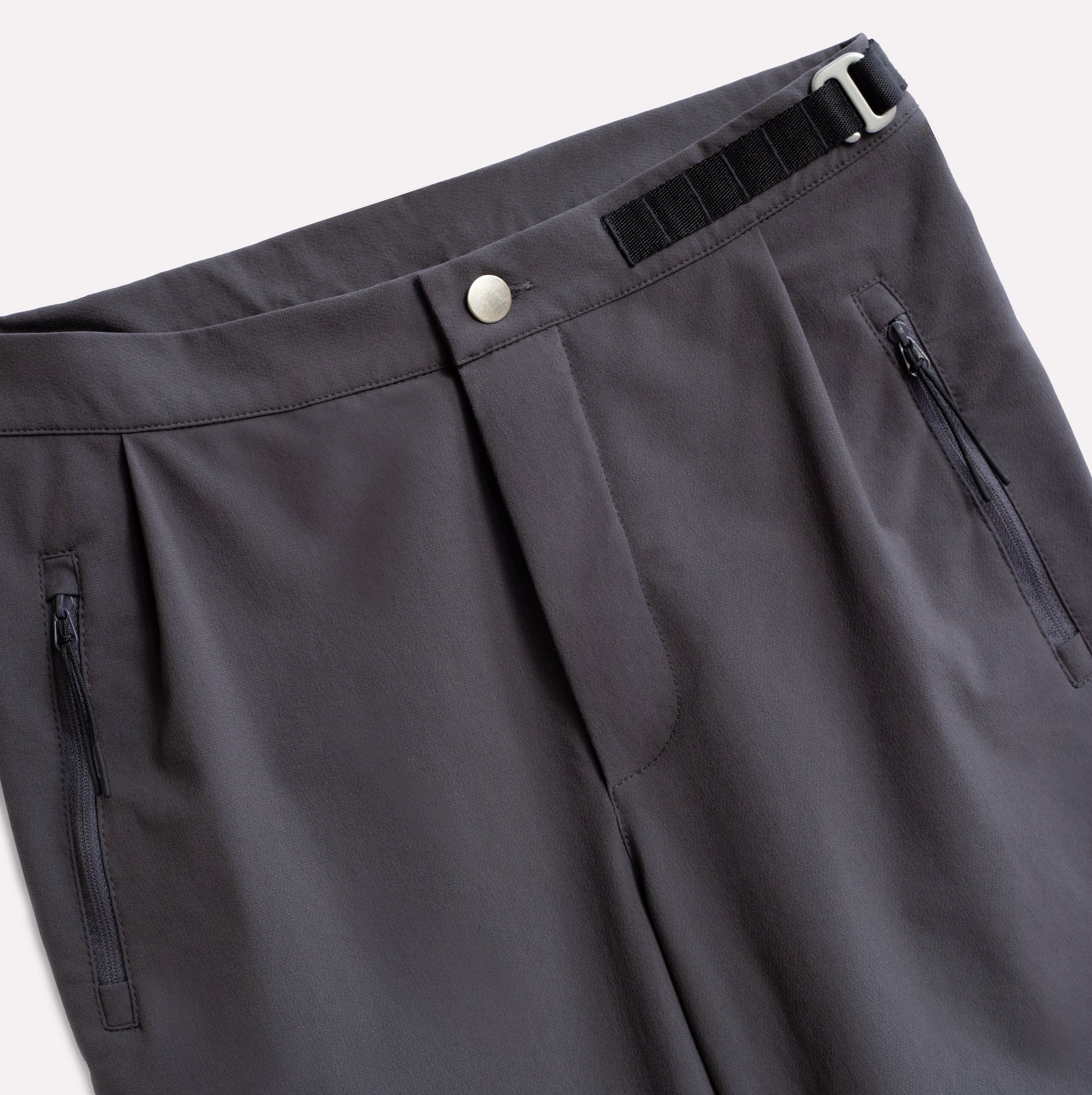 Grey pants for climbing with zip pockets.
